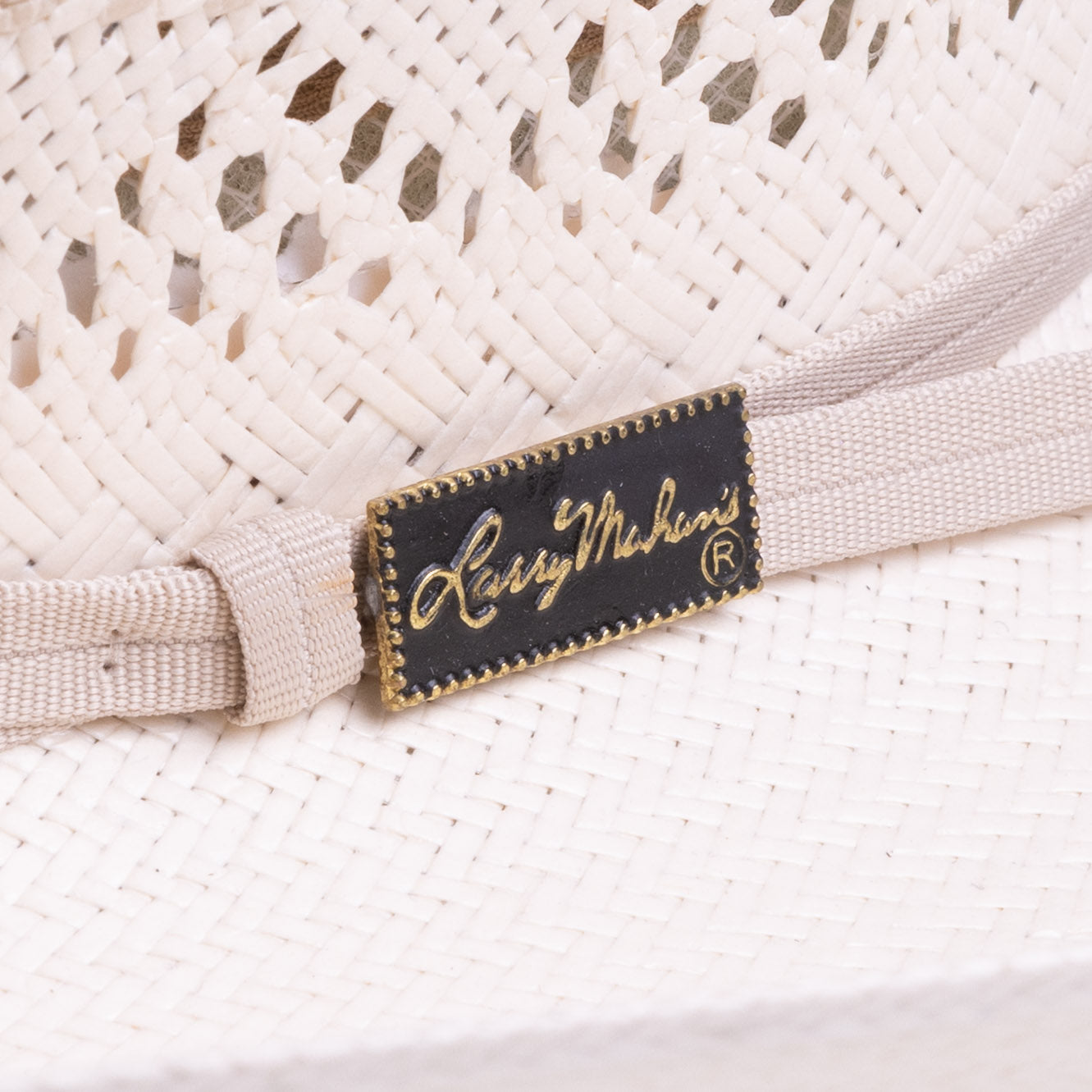 10X Durant ivory cowboy hat closeup of buckle as a black rectangle with golden dots around the outside and Larry Mahan's logo on the inside