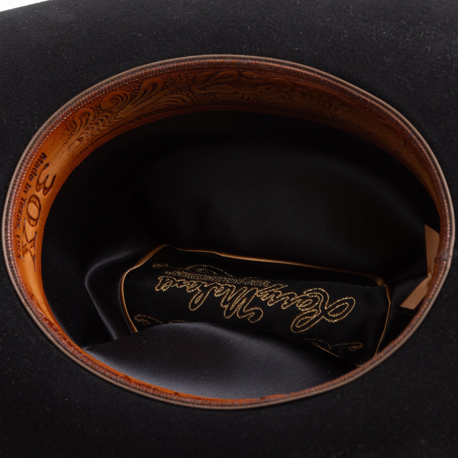 30X Opulento black cowboy hat underside with brown leather band with text and black interior with gold writing in the center