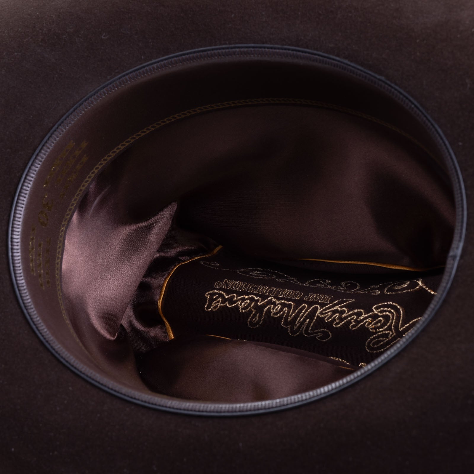 30X El Rey brown cowboy hat closeup of the underside with brown interior and trim with gold lettering around the edges