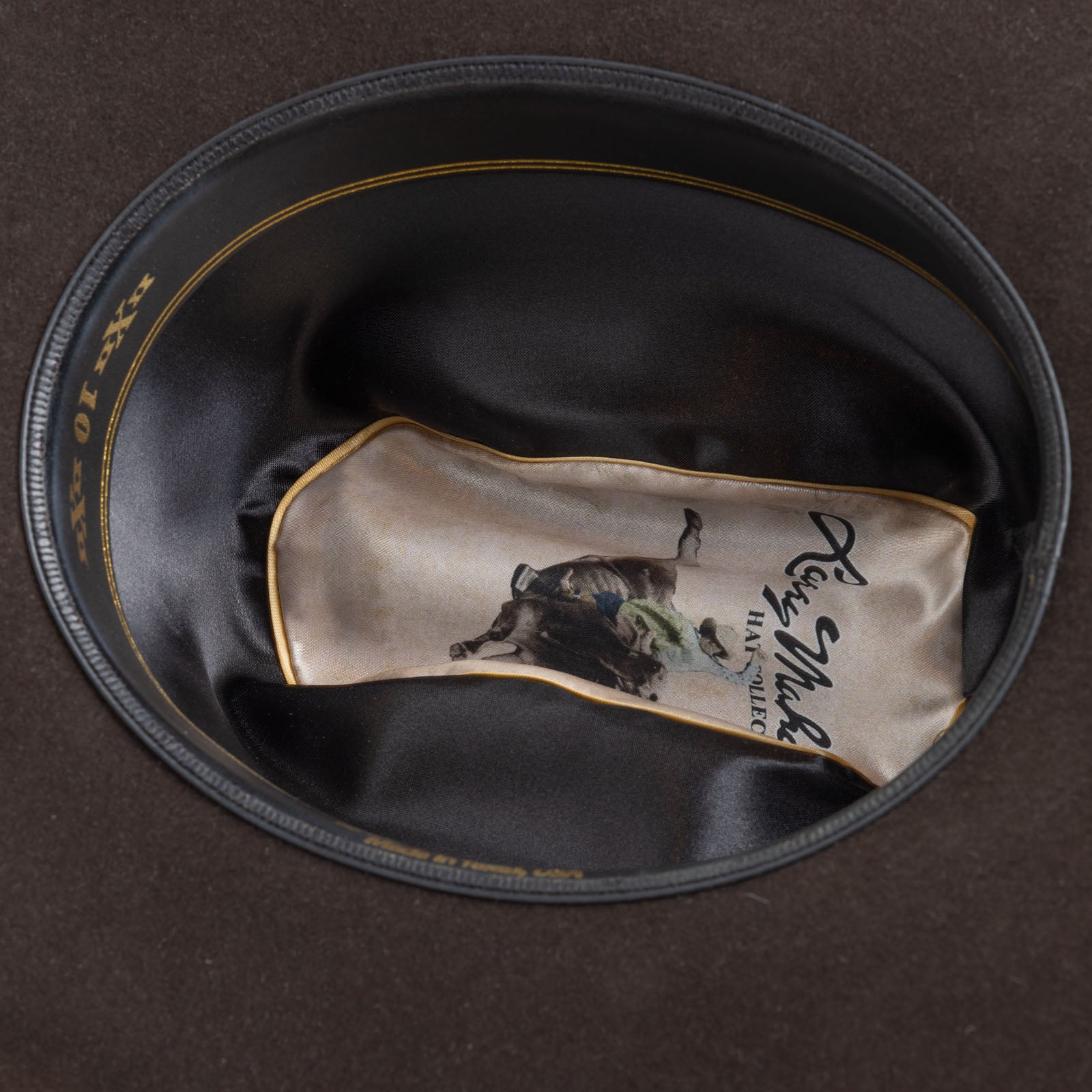 5X Fort Worth brown cowboy hat closeup of the underside with black interior, gold trim and lettering