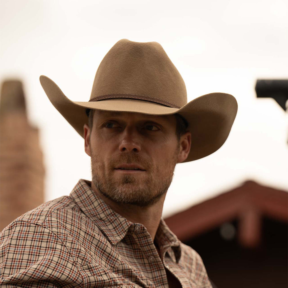 Bearded man wearing a 3X Bandera fawn cowboy hat and red, blue, and tan plaid long sleeve shirt