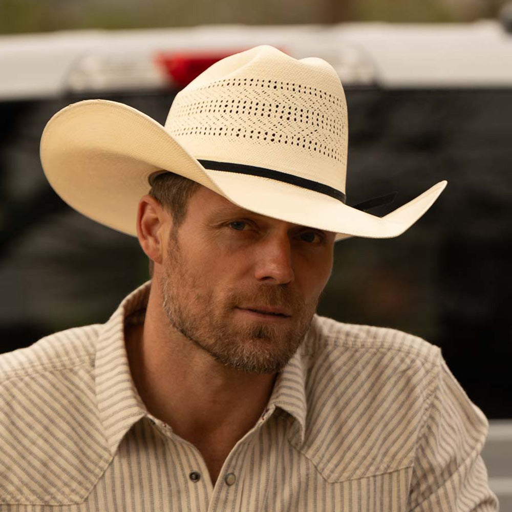 Bearded man wearing a 10X Cowboy Weston belly cowboy hat and white plaid shirt