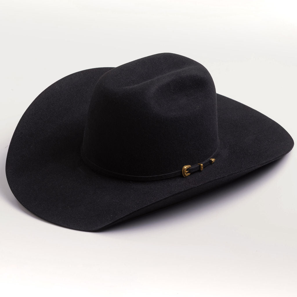 A black felt cowboy hat with a small gold buckle detail on the band, photographed on a clean light gray background