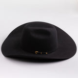 A black felt cowboy hat with a small gold buckle detail on the band, photographed on a clean light gray background