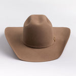 A classic felt cowboy hat in a fawn brown color, featuring a small gold-tone buckle on the band, set against a clean light gray background