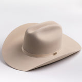 A light beige felt cowboy hat with a matching band and a small gold-toned buckle, photographed on a clean light gray background