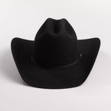 A black felt cowboy hat with a curved brim and a small gold brand plaque on the band, photographed on a light gray background