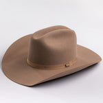 A classic felt cowboy hat in a fawn brown color, featuring a matching band with a small gold-tone metal buckle, photographed on a light gray background