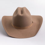 A classic felt cowboy hat in a fawn brown color, featuring a matching band with a small gold-tone metal buckle, photographed on a light gray background