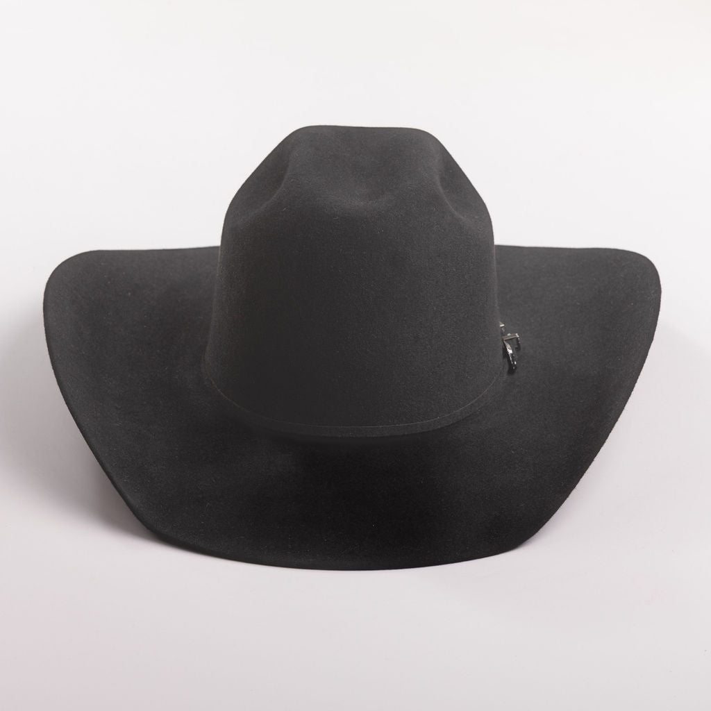 A black felt cowboy hat with a small silver decorative buckle on the band, photographed on a clean light gray background