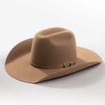 A classic felt cowboy hat in a warm tan-brown color, featuring a small silver-toned decorative buckle on the band, set against a clean light gray background