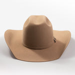 A classic felt cowboy hat in a warm tan-brown color, featuring a small silver-toned decorative buckle on the band, set against a clean light gray background