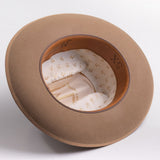 A fawn brown colored wide-brim felt hat shown from an overhead angle, displaying its cream-colored patterned interior lining and brown inner band with 5X text