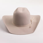 A light beige felt cowboy hat with a matching band and a small round gold-tone button, photographed on a clean light gray background
