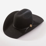 A black felt cowboy hat with a wide brim, a black ribbon band, and a small round gold button accent, photographed on a clean light gray background