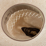 10X Cowboy Cruz tan and ivory cowboy hat closeup of the underside with yellowish interior, light brown trim and dark brown lettering