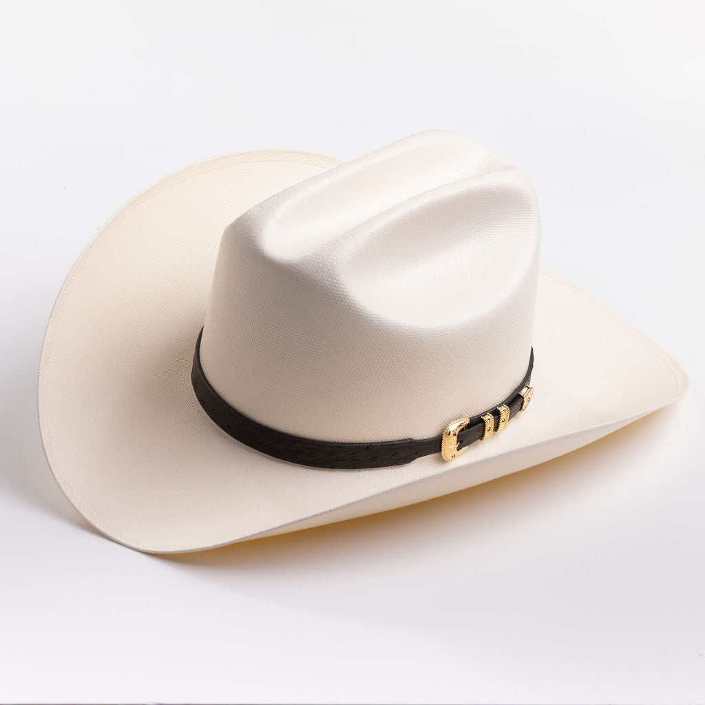 An off-white cowboy hat with a black band and gold buckle, photographed on a clean light gray background