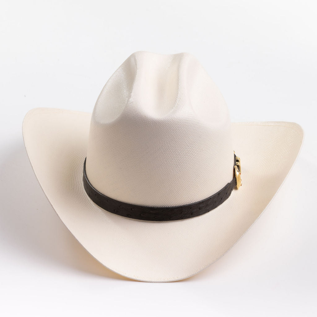 An off-white cowboy hat with a black band and gold buckle, photographed on a clean light gray background
