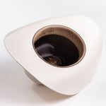 A cream-colored cowboy hat shown from an overhead angle, displaying its wide brim, textured crown, and interior lining with "100X" printed on the inside