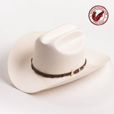 An off-white colored cowboy hat with a dark brown band and gold buckle, photographed on a clean white background - fish band in red is stamped in the top right corner of the photo