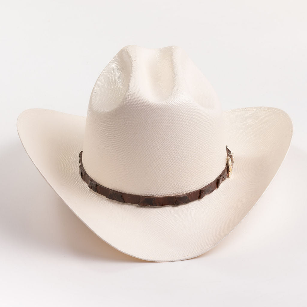 An off-white cowboy hat with a dark brown textured band, photographed on a clean white background
