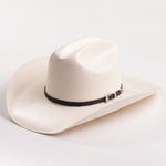 An off-white cowboy hat with a black band and a silver buckle, photographed on a clean white background
