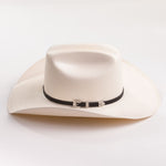 An off-white cowboy hat with a black band and silver conchos, photographed on a clean white background