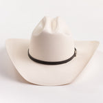 An off-white cowboy hat with a black band and a small silver buckle, photographed on a clean white background