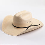 A light beige woven straw cowboy hat with a black ribbon band and a small silver buckle, photographed on a clean white background