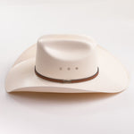An off-white cowboy hat with a brown band and silver metal accents, photographed on a clean white background