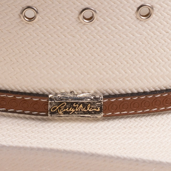 Close-up of an off-white cowboy hat featuring silver-tone eyelets and a brown leather band accented by a silver-toned metal logo plaque reading as 'Larry Mahan's'