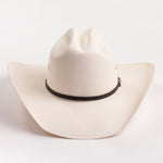 An off-white woven cowboy hat with a black band around the crown, photographed against a clean white background