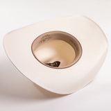 An off-white colored cowboy hat photographed from an overhead angle, showing the interior crown and printed inner lining text