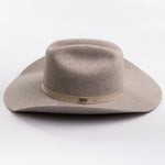 A light taupe felt cowboy hat with a matching felt crown and a beige fabric band around the middle, photographed on a clean light gray background
