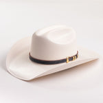 Ivory cowboy hat with a decorative band on a light gray background
