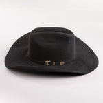 Black cowboy hat with a gold band on a gray background
