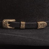 Close-up of a black belt with gold buckle