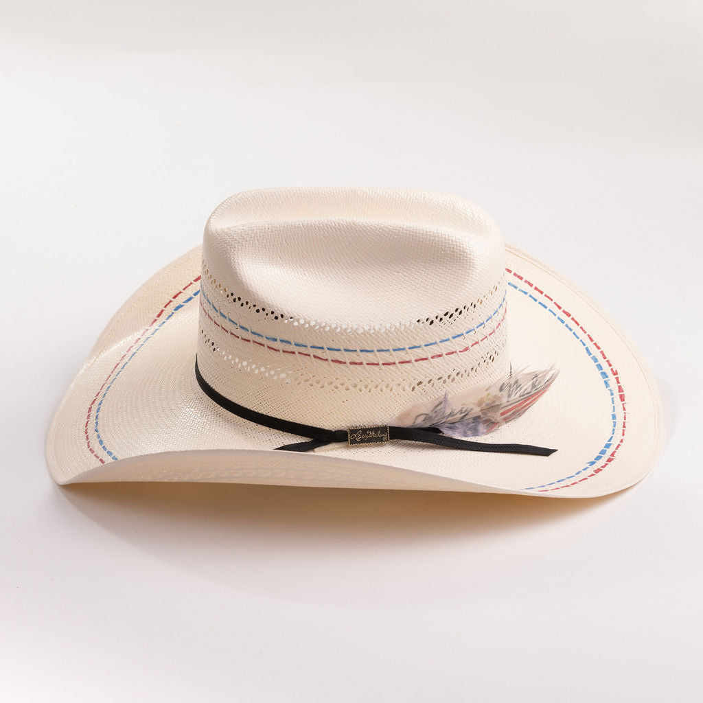 Ivory cowboy hat with decorative band and feather on a gray background