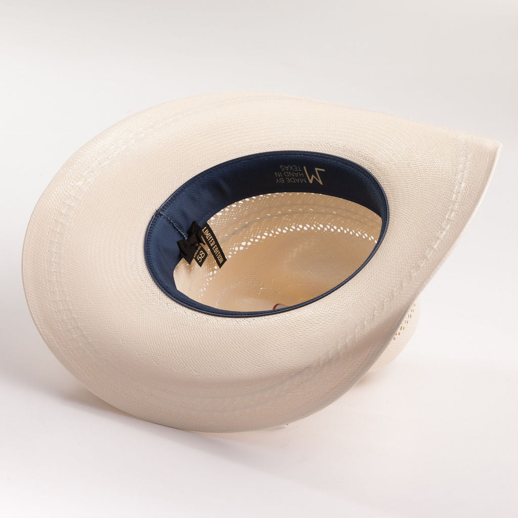 Ivory cowboy hat with blue interior on a gray background