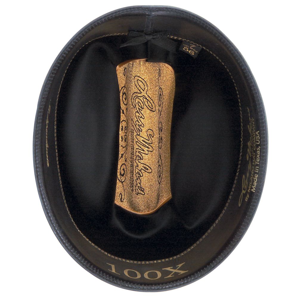 100X Independencia black cowboy hat underside with brown band with light brown text and black interior gold gold center with golden Larry Mahan bottom-most part