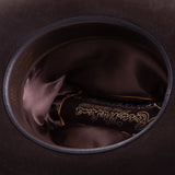 30X El Rey brown cowboy hat closeup of the underside with brown interior and trim with gold lettering around the edges