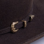 5X Dorado brown cowboy hat closeup of buckle in gold with small intricate etchings on a brown band