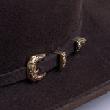 5X Dorado brown cowboy hat closeup of buckle in gold with small intricate etchings on a brown band