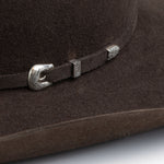 5X Fort Worth brown cowboy hat closeup of buckle in silver with small intricate etchings on a brown band