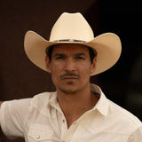 Man wearing a 10X Brindle brown cowboy hat with a white short sleeve shirt