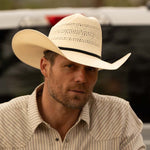 Bearded man wearing a 10X Cowboy Weston belly cowboy hat and white plaid shirt