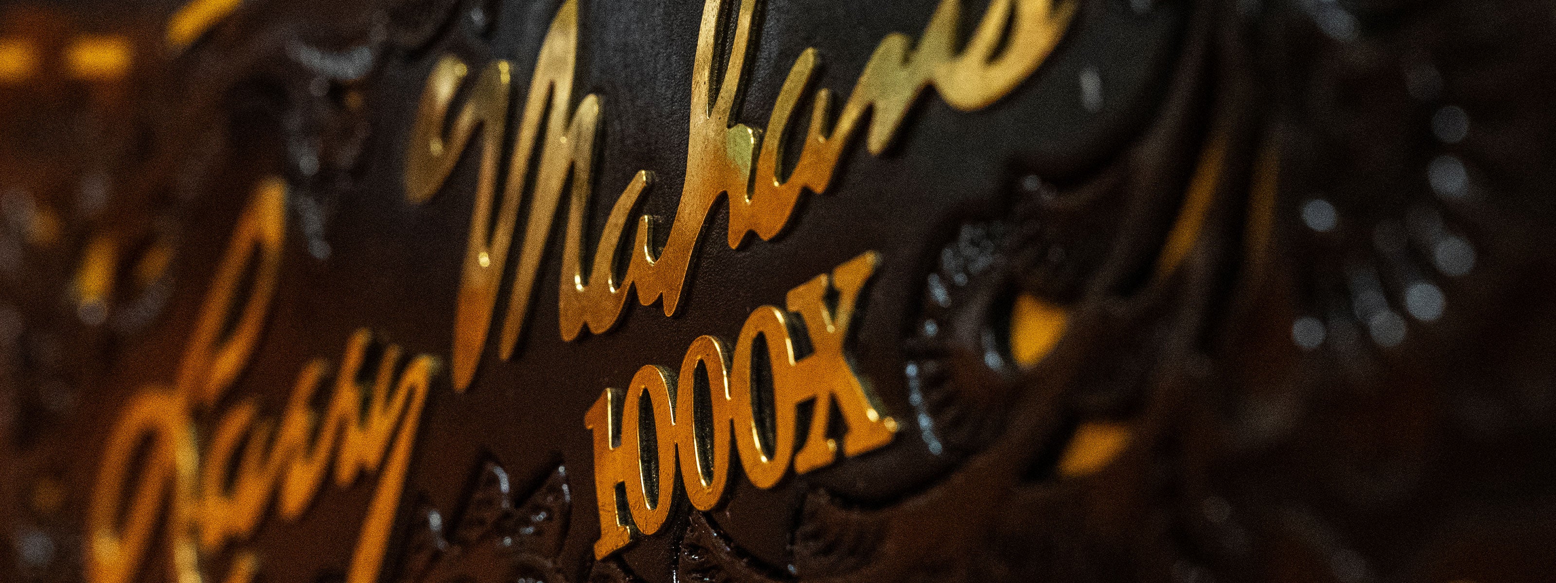 Closeup photo of the Larry Mahan 1000X dark brown box with gold lettering and ribbon